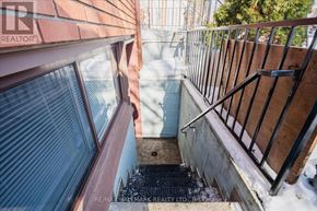 Toronto (East End-Danforth) duplex for rent - A view from a window looking down a snowy staircase.
