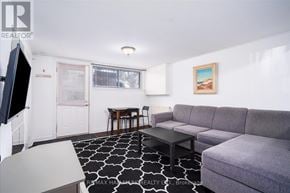 Toronto (East End-Danforth) duplex for rent - A living room with a grey couch and a black and white rug.