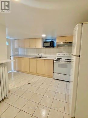 Toronto (Trinity-Bellwoods) apartment for rent - A kitchen with white appliances and a white refrigerator.