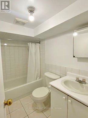 Toronto (Trinity-Bellwoods) apartment for rent - A white bathroom with a toilet, sink, and shower.