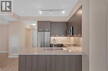 Mississauga condo for rent - A modern kitchen with a sink and a countertop.