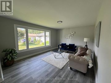 London South (South X) apartment for rent - A living room with a blue couch and a glass table.