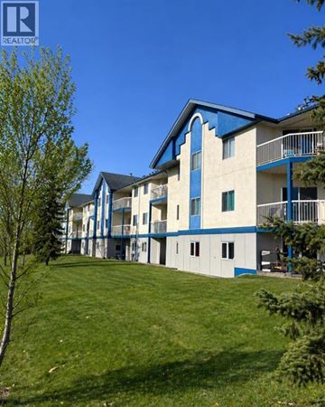 Grande Prairie apartment for rent - A kitchen with white cabinets and a black countertop.