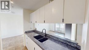 Grande Prairie apartment for rent - A kitchen with a sink and cabinets.