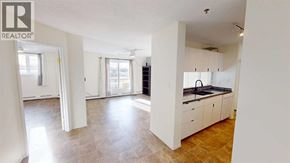 Grande Prairie apartment for rent - A spacious kitchen with white cabinets and a tiled floor.