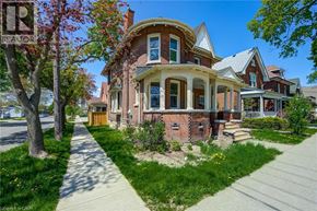 Brantford apartment for rent - A house with a red brick facade and a white trim is shown.