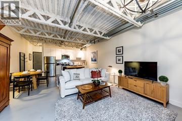 Vancouver apartment for rent - A living room with a white couch and a wooden coffee table.