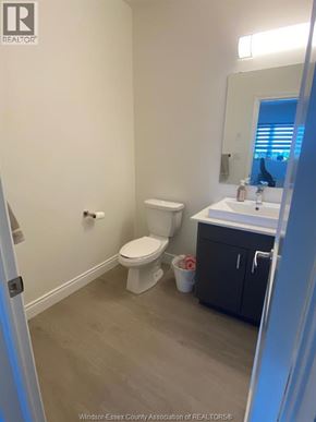 Lasalle apartment for rent - A bathroom with a toilet, sink and mirror.