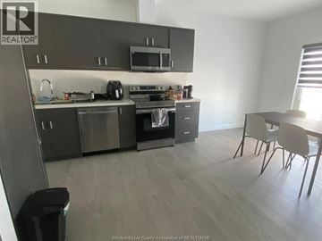 Lasalle apartment for rent - A kitchen with a dining table and chairs.