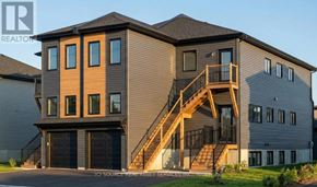 St. Catharines (E. Chester) apartment for rent - A modern house with a garage and a staircase leading to the second floor.