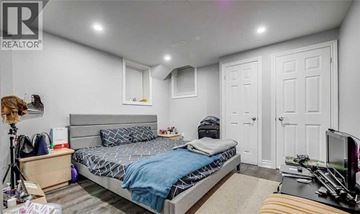 Milton apartment for rent - A bedroom with a bed, a dresser, and a TV.
