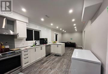 Bradford West Gwillimbury (Bradford) apartment for rent - A kitchen with white cabinets and appliances is shown.