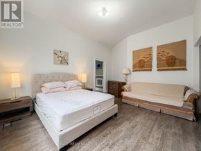 Richmond Hill (Oak Ridges Lake Wilcox) apartment for rent - A bedroom with a large bed and a sofa.