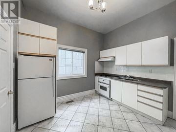 Richmond Hill (Oak Ridges Lake Wilcox) apartment for rent - A kitchen with white cabinets and a white refrigerator.