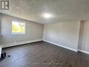 London South (South I) multi-family for rent - A room with a window and wooden flooring.
