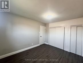London South (South I) multi-family for rent - A room with a door and a window with a white wall and a wooden floor.