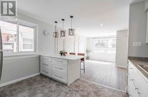 London South (South E) apartment for rent - A kitchen with white cabinets and a wooden floor.
