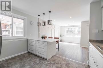 London South (South E) apartment for rent - A kitchen with white cabinets and a wooden floor.