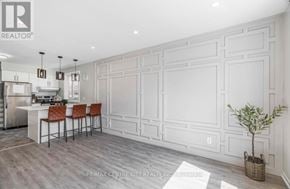 London South (South E) apartment for rent - A kitchen with white cabinets and a bar area with chairs.