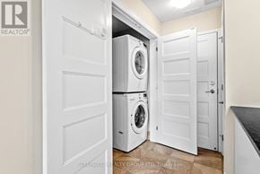 Russell multi-family for rent - A laundry room with a washer and dryer stacked on top of each other.