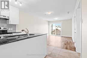 Russell multi-family for rent - A kitchen with a granite countertop and a view of a balcony outside.