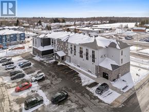 Russell multi-family for rent - A parking lot with cars and a building in the background.