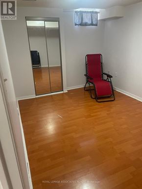 Markham (Cedarwood) apartment for rent - A room with a wooden floor and a red chair.