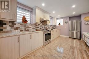 Oakville (Go Glenorchy) apartment for rent - A kitchen with wooden cabinets and a tile backsplash.