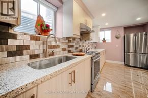 Oakville (Go Glenorchy) apartment for rent - A kitchen with a sink, stove, and refrigerator.