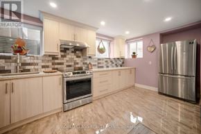 Oakville (Go Glenorchy) apartment for rent - A kitchen with wooden cabinets and a stainless steel refrigerator.
