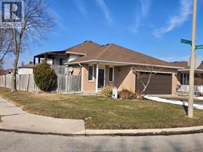 Windsor apartment for rent - A house with a brown roof and a white fence is in front of a blue sky.