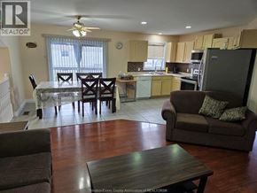 Windsor apartment for rent - A living room with a brown couch and a dining table.