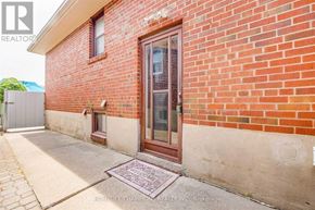 Toronto (Downsview-Roding-Cfb) apartment for rent - A red brick house with a brown door and a small window above the door.