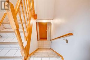 Toronto (Downsview-Roding-Cfb) apartment for rent - A wooden staircase with a tiled floor.
