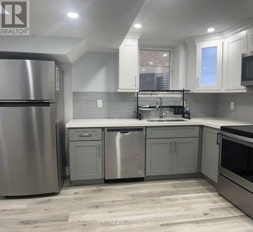 Mississauga (Hurontario) apartment for rent - A modern kitchen with a stainless steel refrigerator and a double sink.