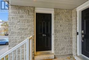 North Grenville townhouse for rent - A house with a black door and number 104 on it.