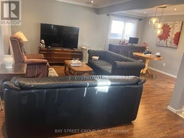 Toronto (Dorset Park) apartment for rent - A living room with a black couch and a television.