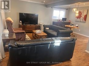 Toronto (Dorset Park) apartment for rent - A living room with a black leather couch and a flat screen TV.