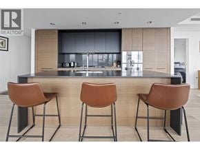 Vancouver apartment for rent - A modern kitchen with a bar stool in front of it.