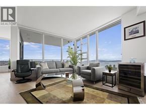 Vancouver apartment for rent - A living room with a large window overlooking the water.