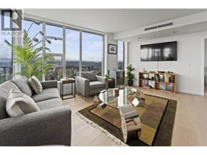 Vancouver apartment for rent - A living room with a large window overlooking the city.