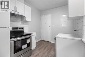 Windsor multi-family for rent - A kitchen with white cabinets and a stove top oven.
