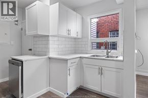 Windsor multi-family for rent - A kitchen with white cabinets and a window.