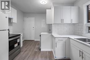 Windsor multi-family for rent - A kitchen with white cabinets and a black oven.