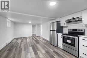 Windsor multi-family for rent - A kitchen with a stove top oven and a refrigerator.