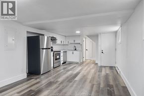 Windsor multi-family for rent - A kitchen with white cabinets and a stainless steel refrigerator.