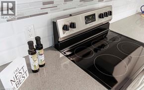 Niagara Falls condo for rent - A stove top oven with a note that says nest best on the counter.