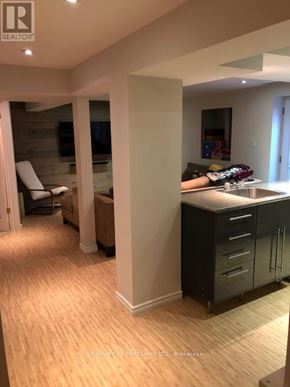 Aurora (Aurora Village) apartment for rent - A well-lit kitchen with a refrigerator, sink, and cabinets.