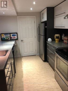 Aurora (Aurora Village) apartment for rent - A kitchen with a white door and a fridge.
