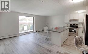 Niagara Falls condo for rent - A kitchen with a refrigerator, sink, and stove.